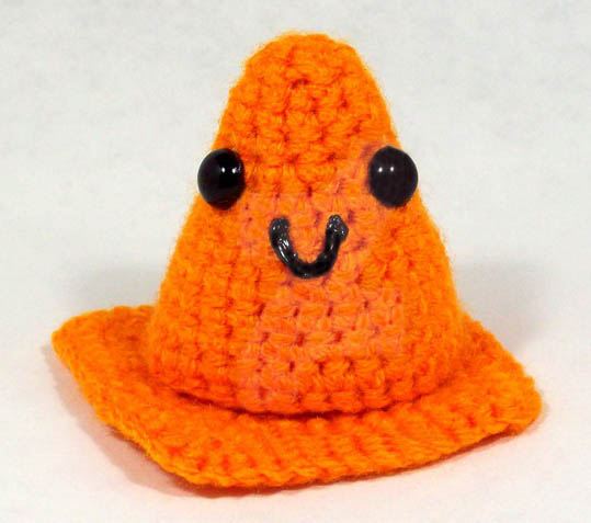 knitted orange safety cone with smiley face